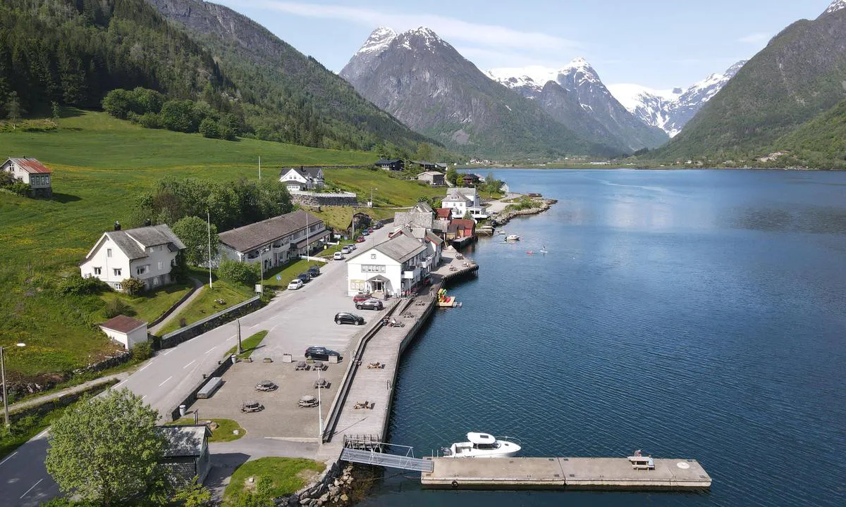 Harbour in Fjærland   Floating and fixed jetty whith markers on depth. Shop for grocery.  Galcier on the mountains.