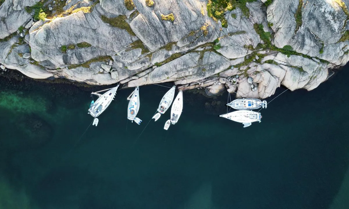 Sailboats moored to the rocks on Tornholmen